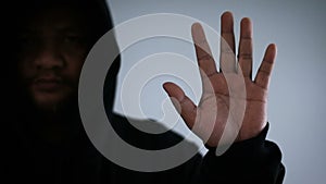 Hacker showing hand and finger with dark tone and grain process concept for futuristic cyber technology criminal