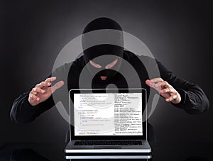 Hacker stealing data of a laptop computer