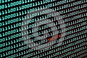 Hacker text and binary code concept from the desktop screen, selective focus