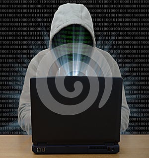 Hacker typing on a laptop