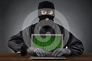 Hacker Typing On Laptop With Binary Code