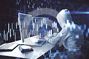 Hacker using computer with business chart