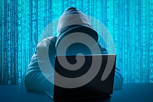 Hacker Using Computer laptop for Organizing Massive Data Breach Attack on Corporate Servers. Underground Secret Location.