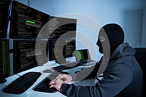 Hacker Using Computers With Multiple Monitors
