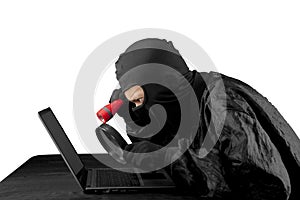 Hacker using flash light and magnifying glass.