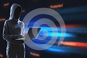 Hacker using laptop with abstract binary code on blurry background. Cyber attack and hacking concept.