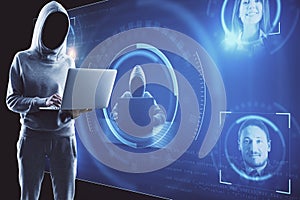 Hacker using laptop with abstract glowing digital interface