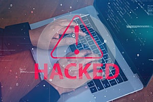 Hacker using a laptop with binary code digital interface.