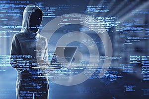 Hacker using laptop with creative coding html language on blurry office interior background. Web developer, hacking, malware and