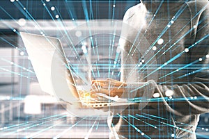Hacker using laptop with creative linear matrix hologram on blurry office interior background. Metaverse, hacking, data theft, vr