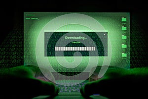 Hacker using laptop. Lots of digits on the computer screen
