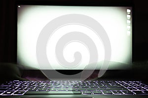Hacker using laptop. Lots of digits on the computer screen