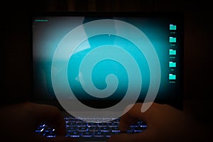Hacker using laptop. Lots of digits on the computer screen