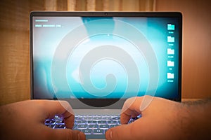 Hacker using laptop. Lots of digits on the computer screen