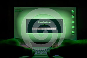 Hacker using laptop. Lots of digits on the computer screen