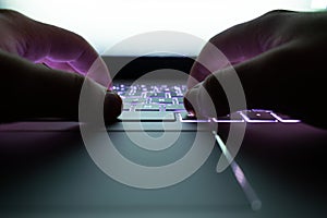 Hacker using laptop. Lots of digits on the computer screen