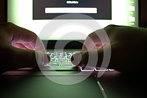 Hacker using laptop. Lots of digits on the computer screen