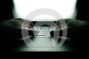 Hacker using laptop. Lots of digits on the computer screen