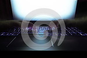 Hacker using laptop. Lots of digits on the computer screen