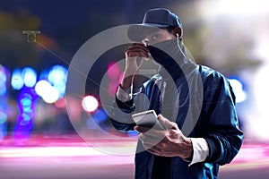 Hacker using mobile phone on the street