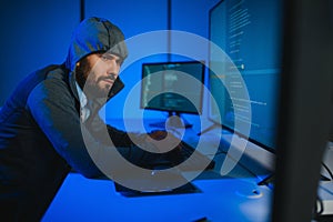 Hacker Using Multiple Computers For Stealing Data On Desk