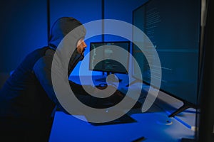Hacker Using Multiple Computers For Stealing Data On Desk