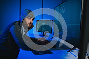Hacker Using Multiple Computers For Stealing Data On Desk