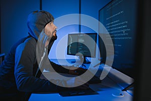Hacker Using Multiple Computers For Stealing Data On Desk
