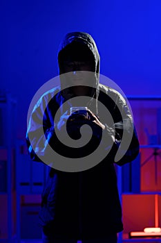 Hacker using smartphone for phishing attack and data theft in dark cyber environment