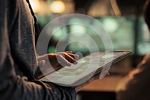Hacker using spyware on digital tablet