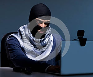 Hacker wearing balaclava mask hacking computer