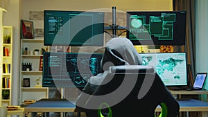 Hacker wearing a hoodie while committing cyber crimes