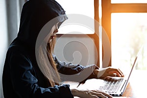 Hacker woman stealing data by using laptop