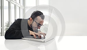 Hacker working on laptop in the office