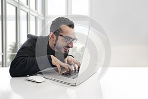 Hacker working on laptop in the office