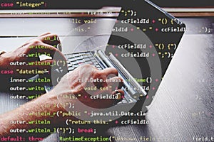 hackers breaking into a computer system. a laptop with codes to break into the security system.