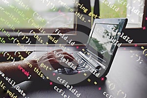 hackers breaking into a computer system. a laptop with codes to break into the security system.