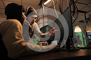 Hackers discussing computer system hacking, coding malicious software