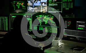 Hackers working on computers showing world maps and security camera footage