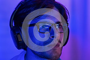 Hacking concept. Man in glasses looking at computer screen