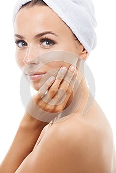 She had a great day at the spa. Beautiful young woman touching her face while isolated against a white background.