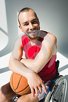 Hadicapped sportsman holding basketball