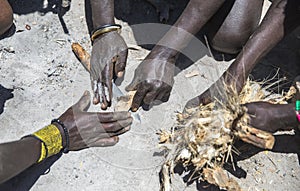 Hadzabe men making fire