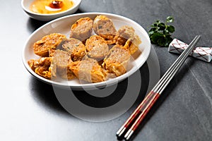 Hae Keung is fried shrimp rolled or shrimp ball. Chinese Traditional cuisine concept. Dumplings Dim Sum in bamboo steamer with