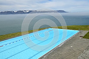 A haeted swimming  pool situated directly on the coast of Icland