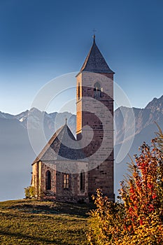 Hafling, Italy - The mountain church of St. Catherine Chiesa di Santa Caterina near Hafling - Avelengo on a warm autumn sunset