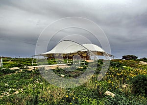 Hagar Qim and Mnajdra prehistoric temple complex with canopy, megalith temple under protective tent on the Mediterranean island of