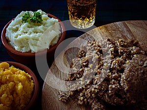 Haggis, with mashed potatoes, mashed swede and a wee dram of Scotch whiskey. Burns Night, Scotland