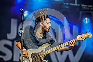 young guitarist with braids performing on stage