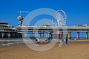 Hague, Netherlands - May 2, 2022: Beautiful view of beach and Scheveningen Pier with Ferris wheel